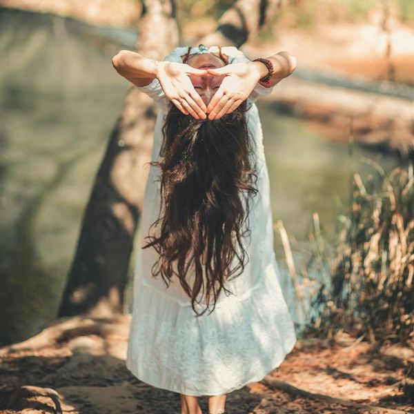 Calm person meditating in a peaceful natural environment.